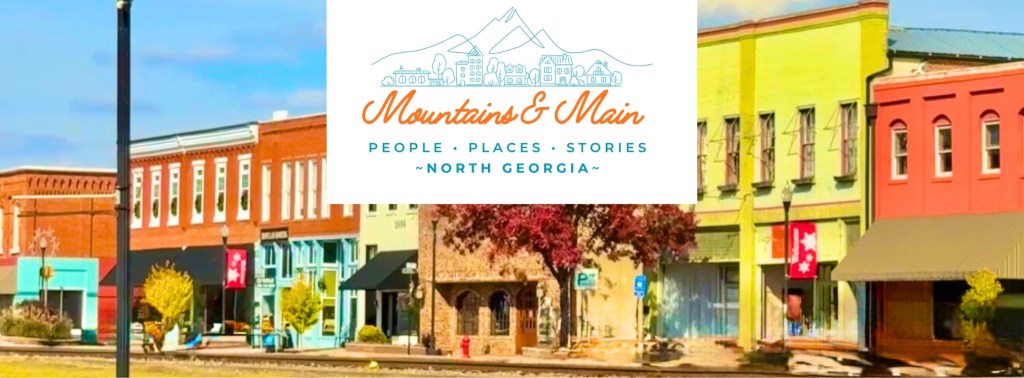 mountains & Main logo with downtown Commerce in background